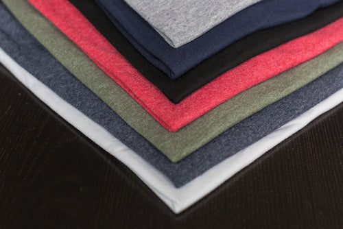 Stack of folded graphic t-shirts in washed black
